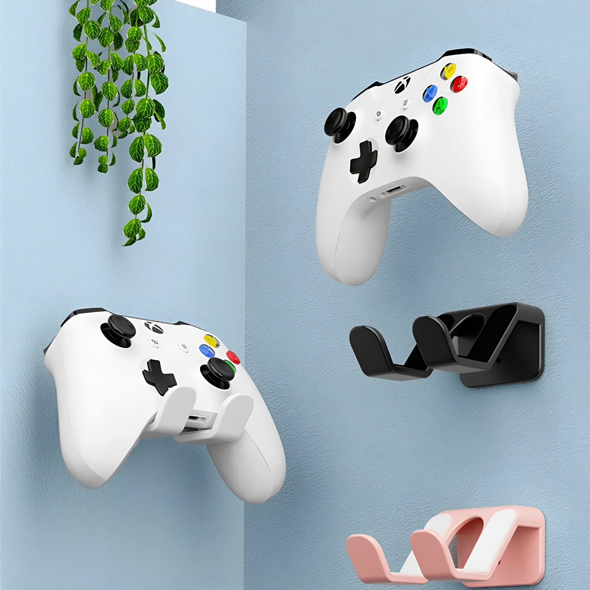Plastic ABS wall-mounted handle rack for organising game controllers, shown in black, white, and pink colour options.