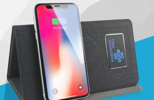 Folding wireless charging mouse pad set with luminous surface, black cloth pad, and wireless mouse on desk