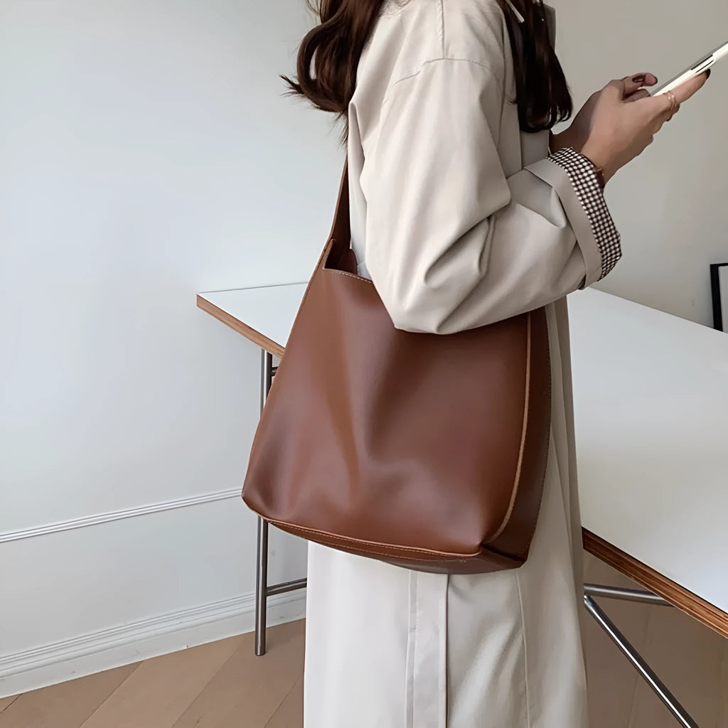 Pair of soft black and brown women's PU shoulder bags with decorative ribbons and swing threads.