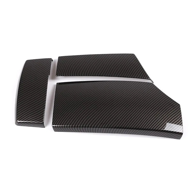 Three black ABS plastic car armrest box covers with a carbon fibre pattern and glossy finish.