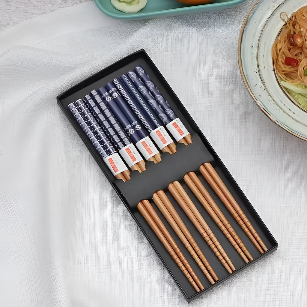 Set of five pairs of bamboo chopsticks with colourful lucky cat cartoon pattern.