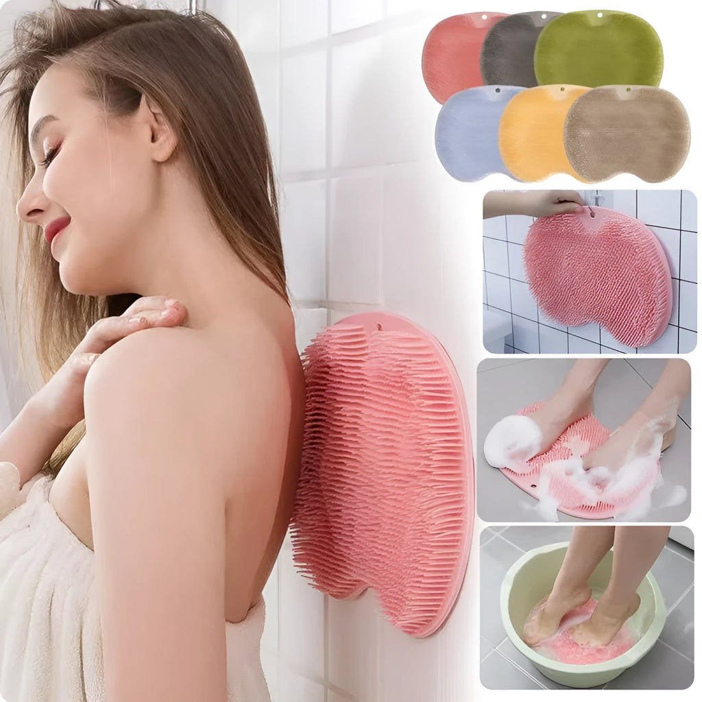 Orange massage bath brush with silicone bristles and suction cup base on a shower floor
