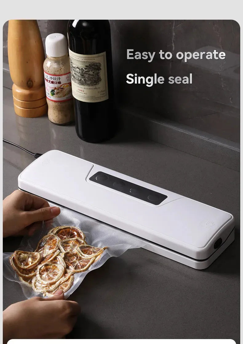 White automatic household vacuum sealer machine on a kitchen countertop.