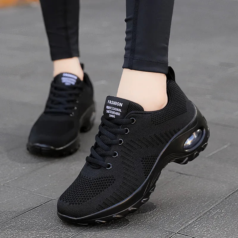 Red women's mesh sneakers with round toe and front lace-up design showing low top silhouette