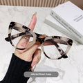 Women's large frame cat's eye reading glasses with dragon and phoenix decorations on the temples.