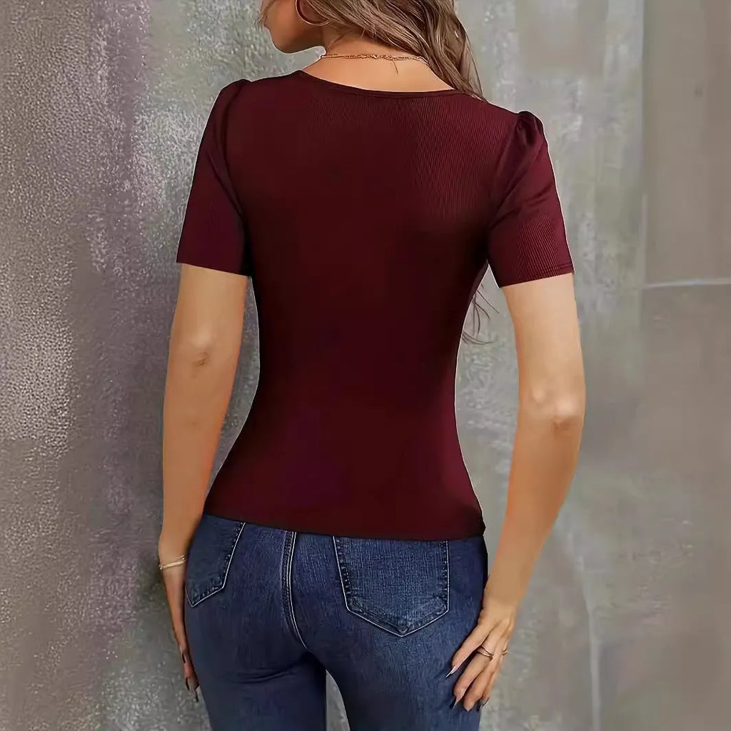 Women's wine red slim fit knitted short sleeve top with low neckline on a hanger.