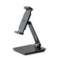 Silver folding aluminium phone and tablet stand with 360° rotation on wooden desk