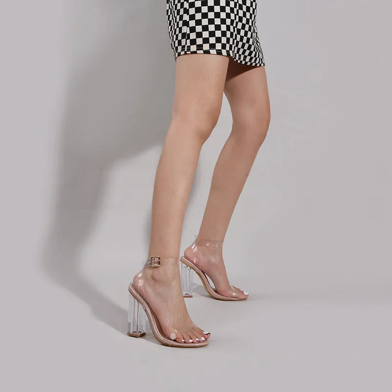 Apricot coloured women's high heel sandals with a clear glass heel and ankle buckle strap.