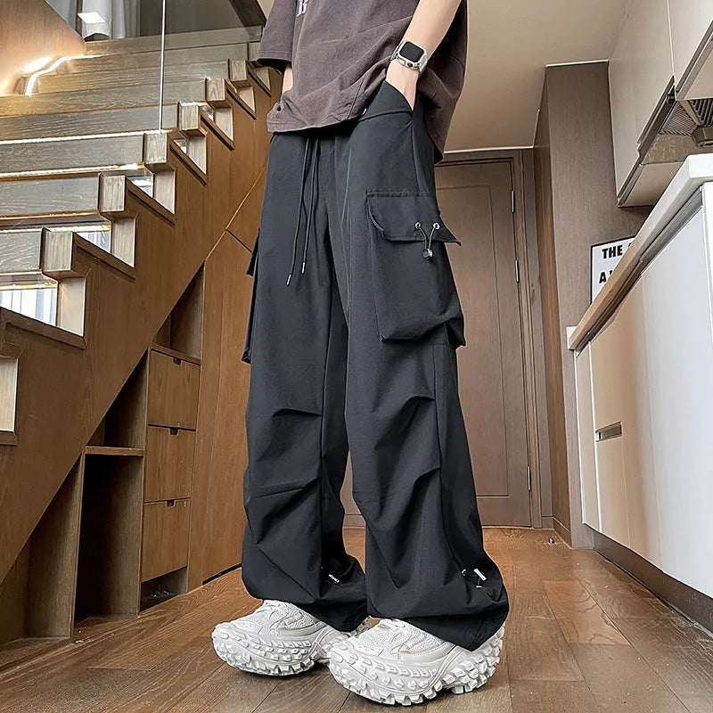 Plus size loose-fit waterproof straight-leg trousers in black on a hanger.