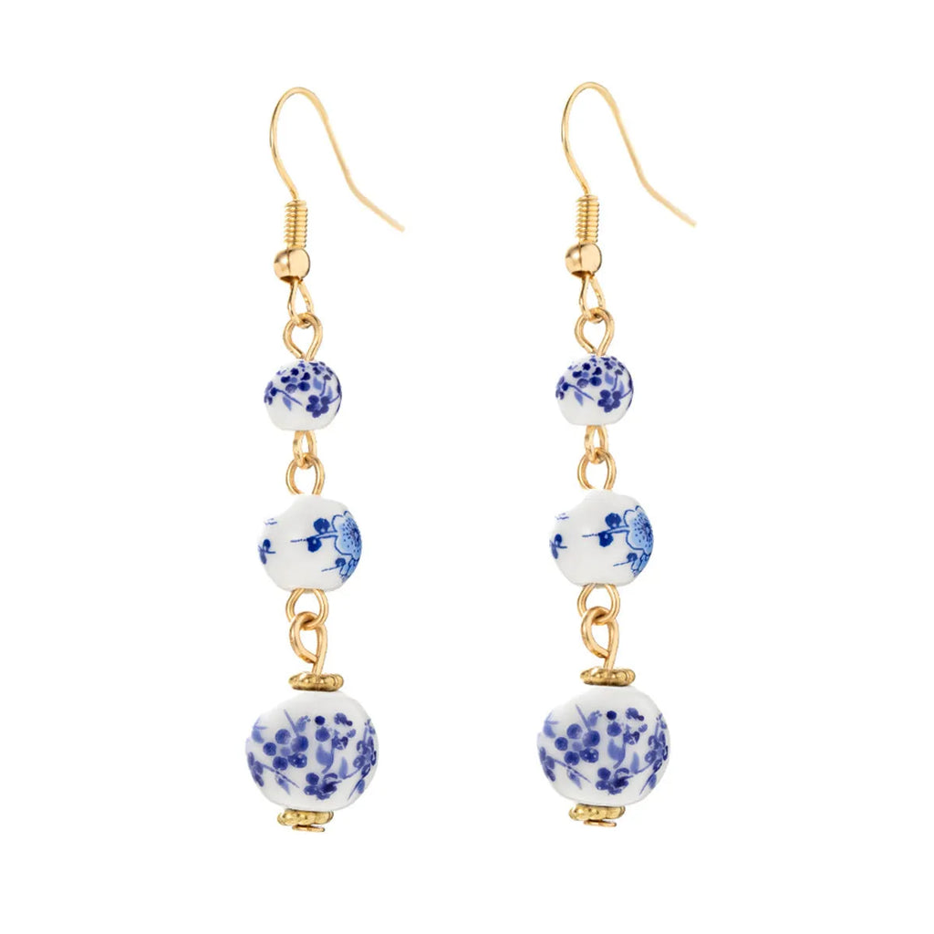 Blue and white porcelain ceramic beads long drop earrings on display with geometric round shape and alloy backing