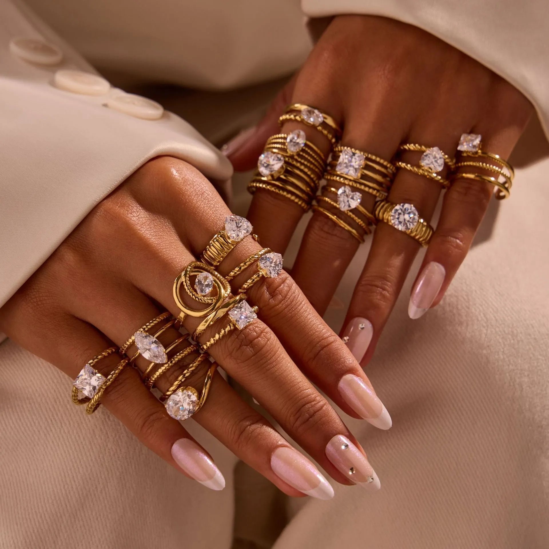 Gold electroplated geometric stainless steel ring with inlaid zircon stones on a finger, showing open mouth design.