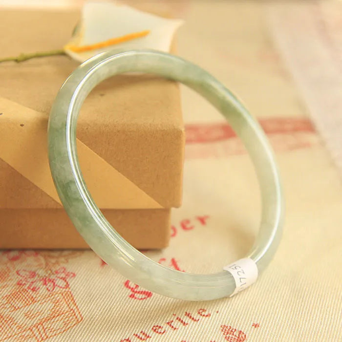 Green waxy jade geometric bracelet on a flat surface, 10mm bead thickness, handcrafted Chinese style