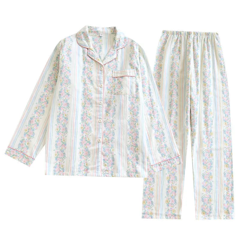 Women's red small fruit print cotton gauze long-sleeved pyjama top and trousers set laid flat.