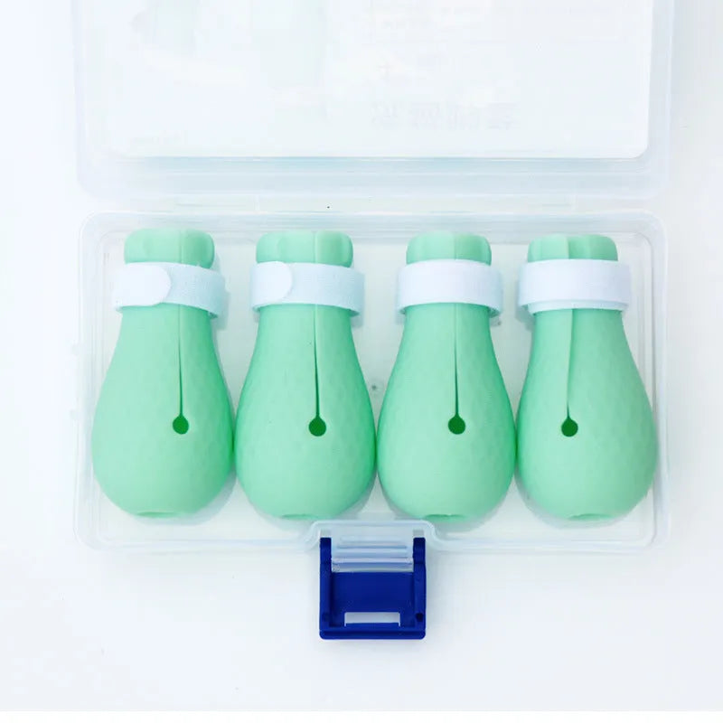 Set of four green silicone cat paw covers designed as anti-scratch gloves for pet washing and medication