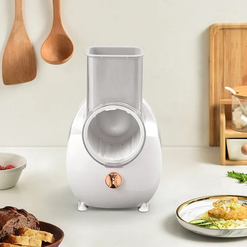 White electric vegetable slicer with suction base and multiple blades for cutting potatoes and carrots
