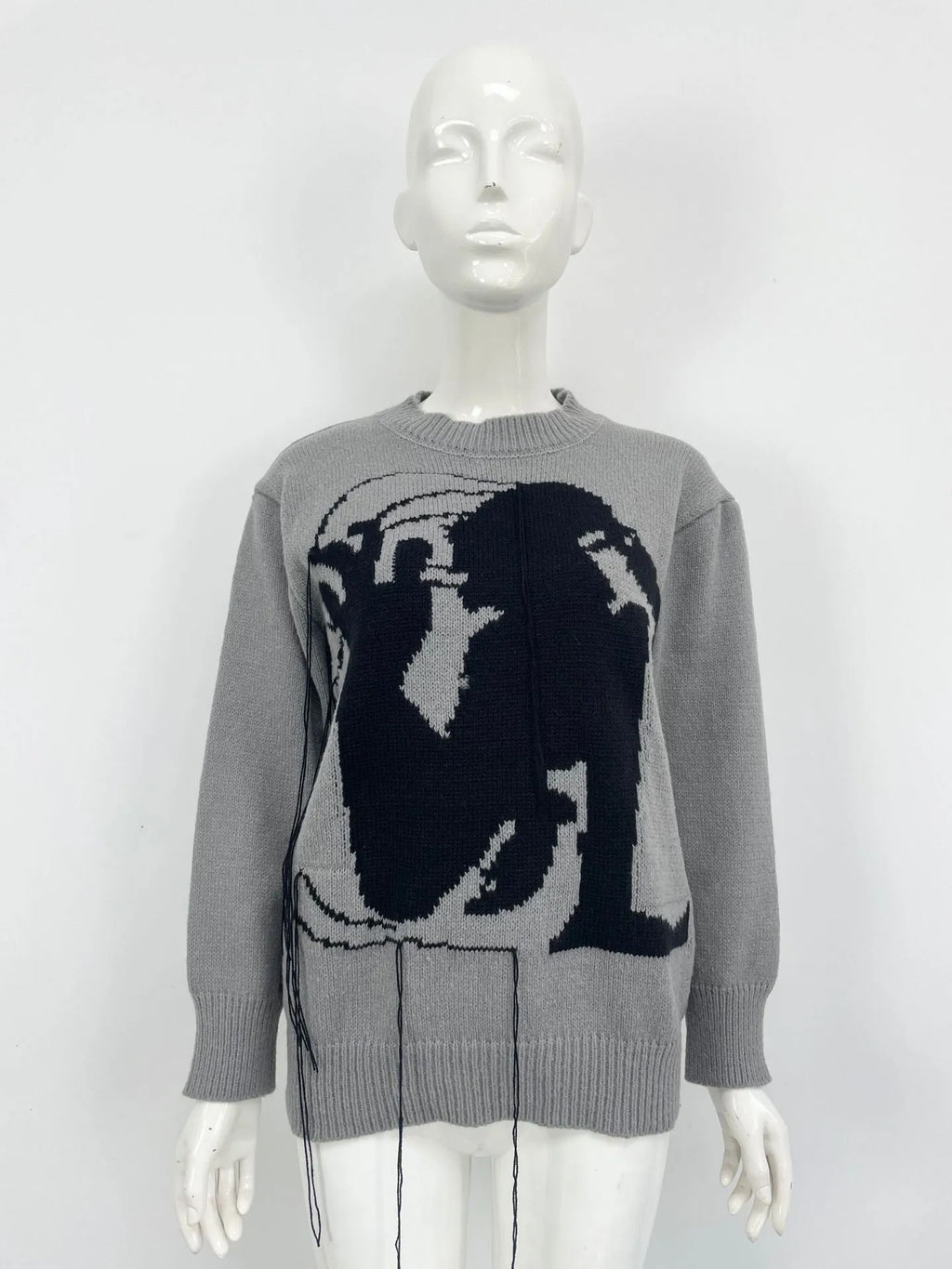 Women's loose alpaca wool tassel sweater in gray, round neck pullover style, side view on model