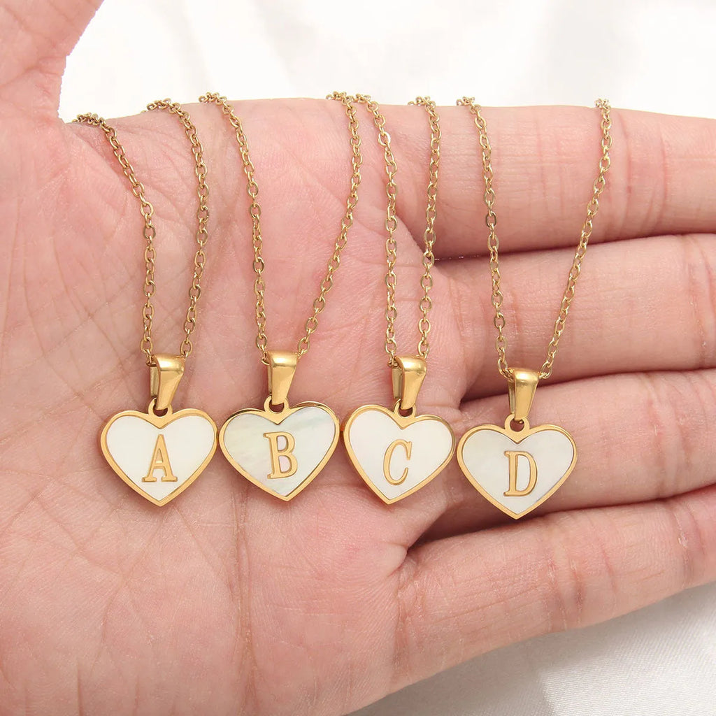 Gold heart necklace with white shell centre on stainless steel chain