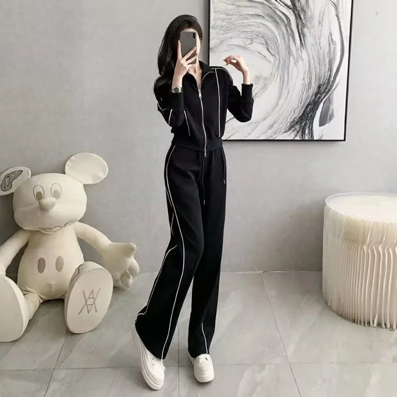 Women's two-piece set with short zipper sweater and wide leg trousers in solid colour polyester, black and white options available