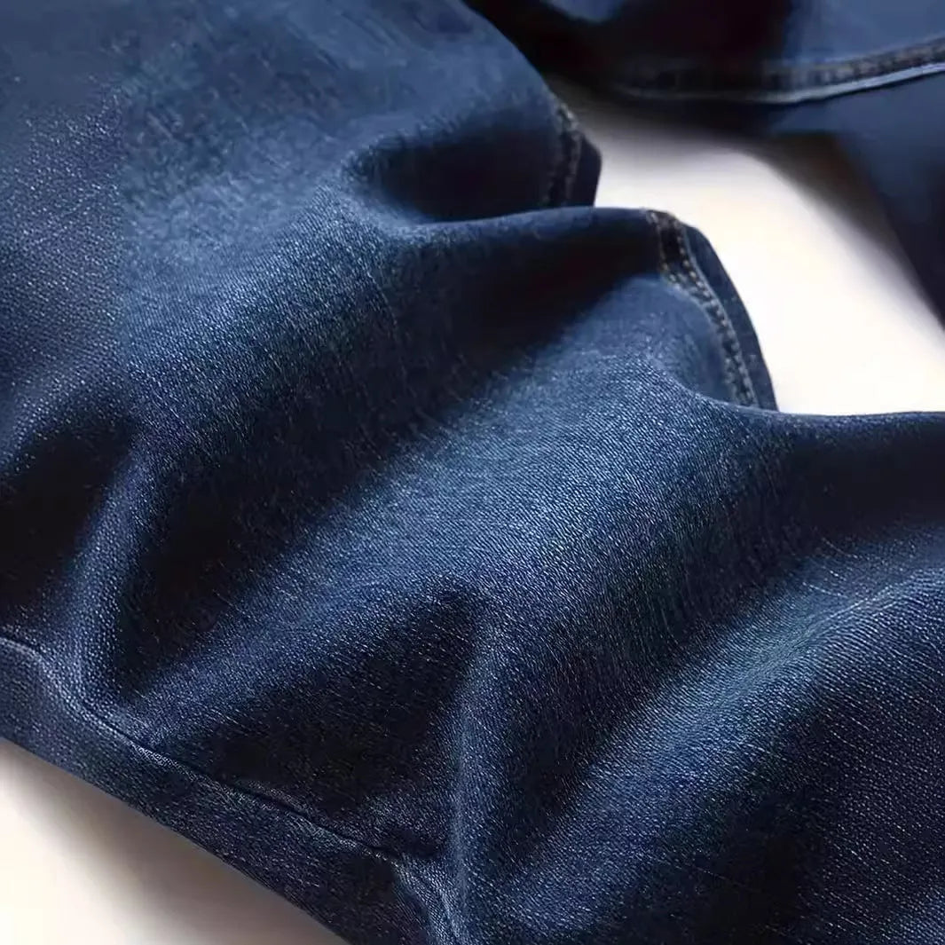 Dark blue men's slim fit casual jeans with a tight leg style and mid waist design.