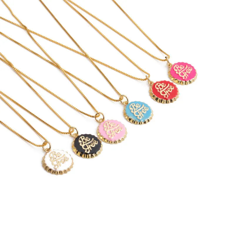 Copper bottle cap pendant necklace with 18k gold electroplating on a box chain, shown in one of six available colours.