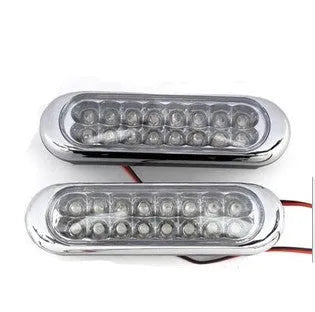 Two white car LED auxiliary lights with iron brackets and screws on a dark background