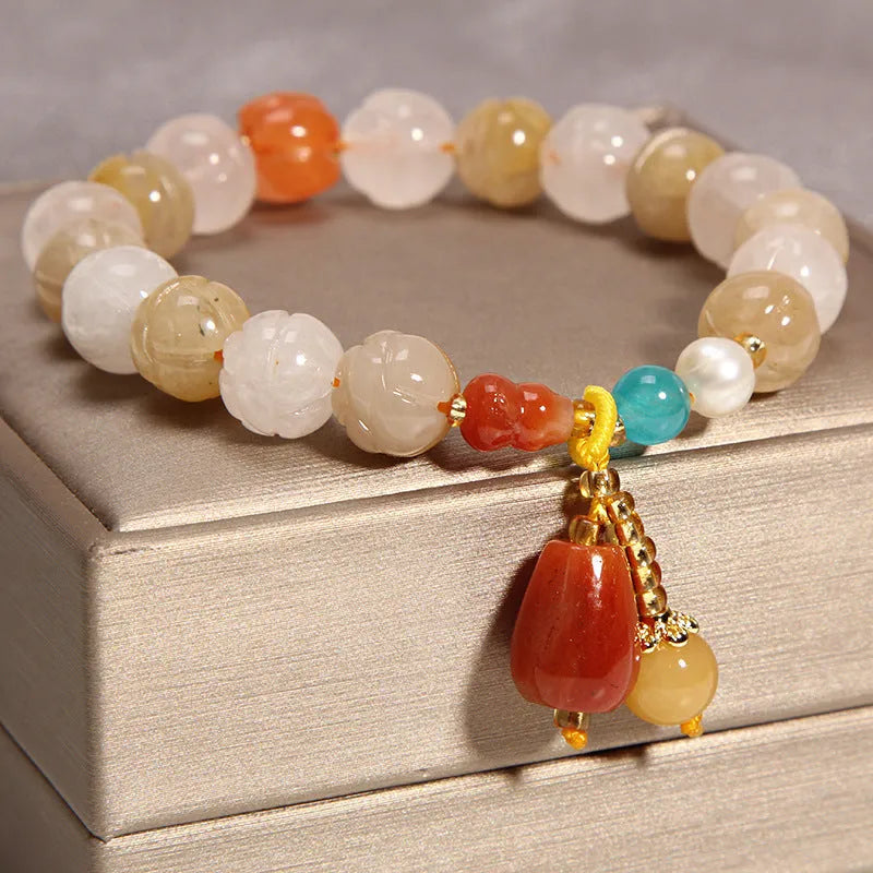 Yellow agate crystal bracelet with gold silk threading on wrist