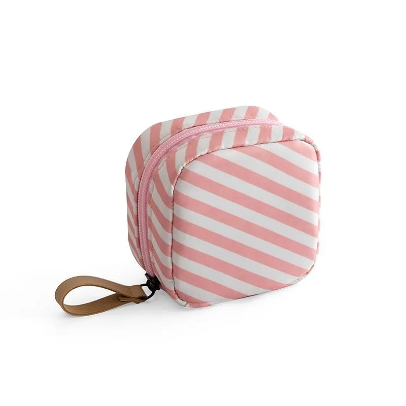 Cloth makeup storage bag with a cube shape and plain pattern, shown in blue colour.