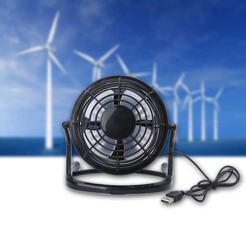 Mini black USB desk fan with adjustable angle for laptop cooling on wooden desk