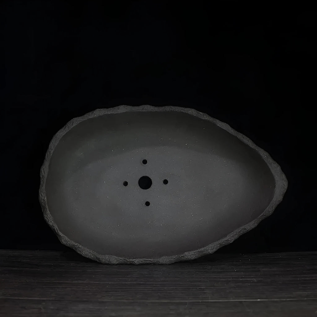 Handmade purple clay flower pot with drainage holes for floor-standing indoor plants