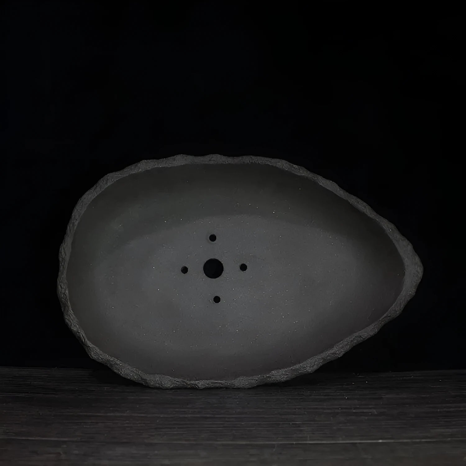 Handmade purple clay flower pot with drainage holes for floor-standing indoor plants