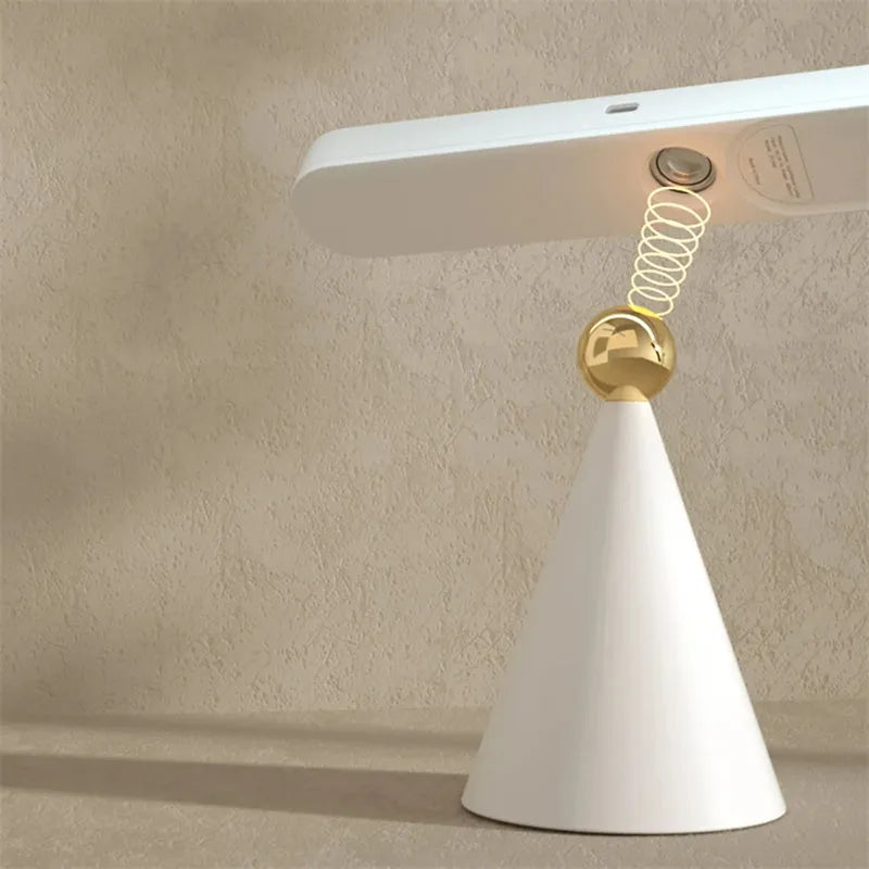 Geometric desk lamp with magnetic base shown in khaki colour with touch control