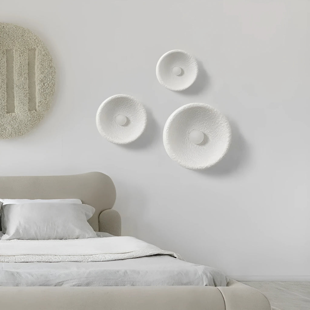 Japanese-style minimalist wall lamp with resin shade in three diameter sizes on white wall