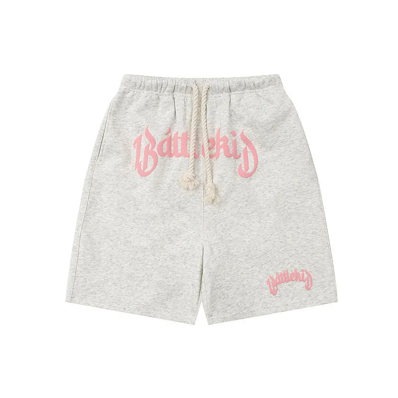 Loose cotton-blend cropped shorts in black, yellow, blue, and grey for street style.