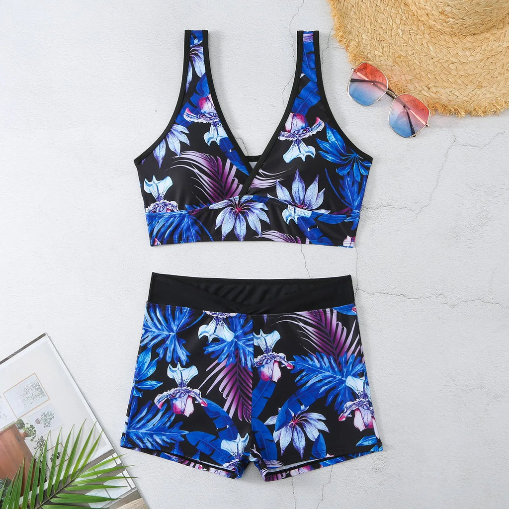 Women's two-piece printed boxer swimsuit set in a multi-colour pattern, showing sleeveless top and briefs.