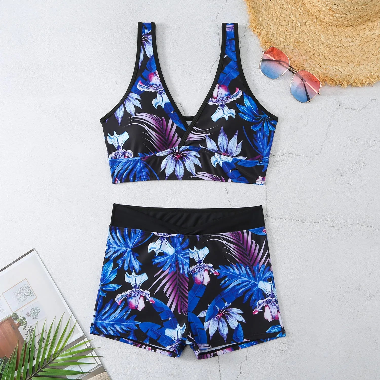 Women's two-piece printed boxer swimsuit set in a multi-colour pattern, showing sleeveless top and briefs.