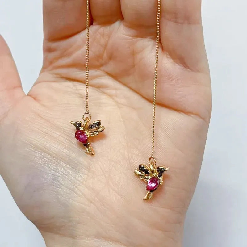 Long style women's earrings with a hanging bird design featuring mixed zirconium wings.