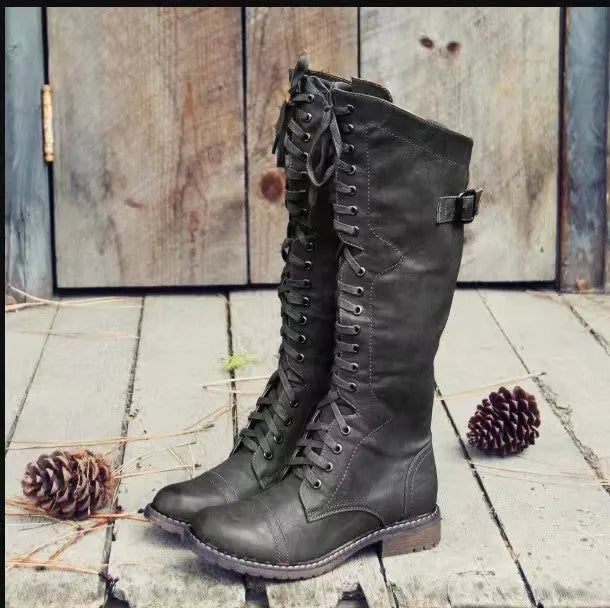 Women's black chunky heel high leg ankle boot with round toe and low rubber sole.