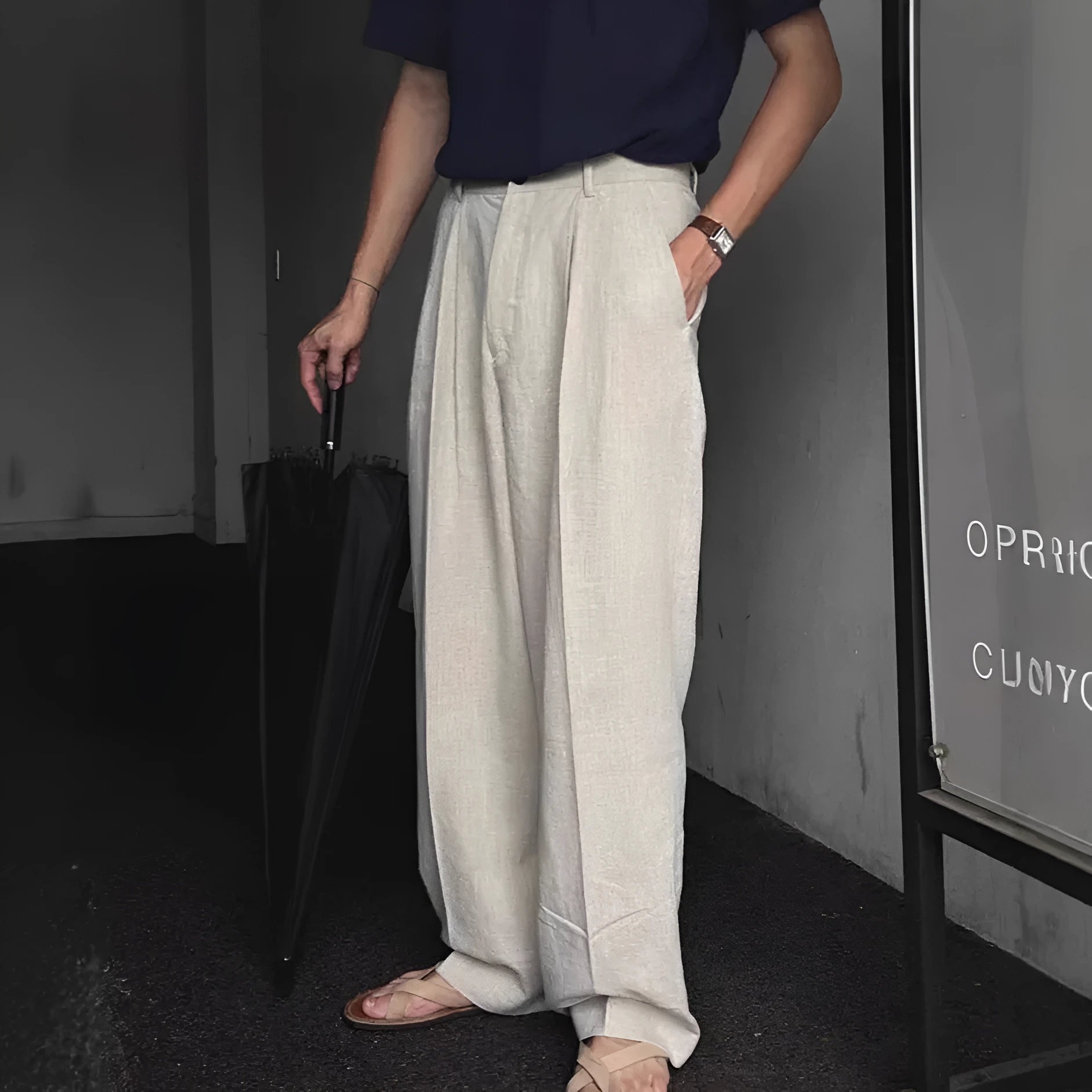 Men's lightweight apricot coloured loose-fit linen trousers laid flat, showing zip fly and relaxed leg style.