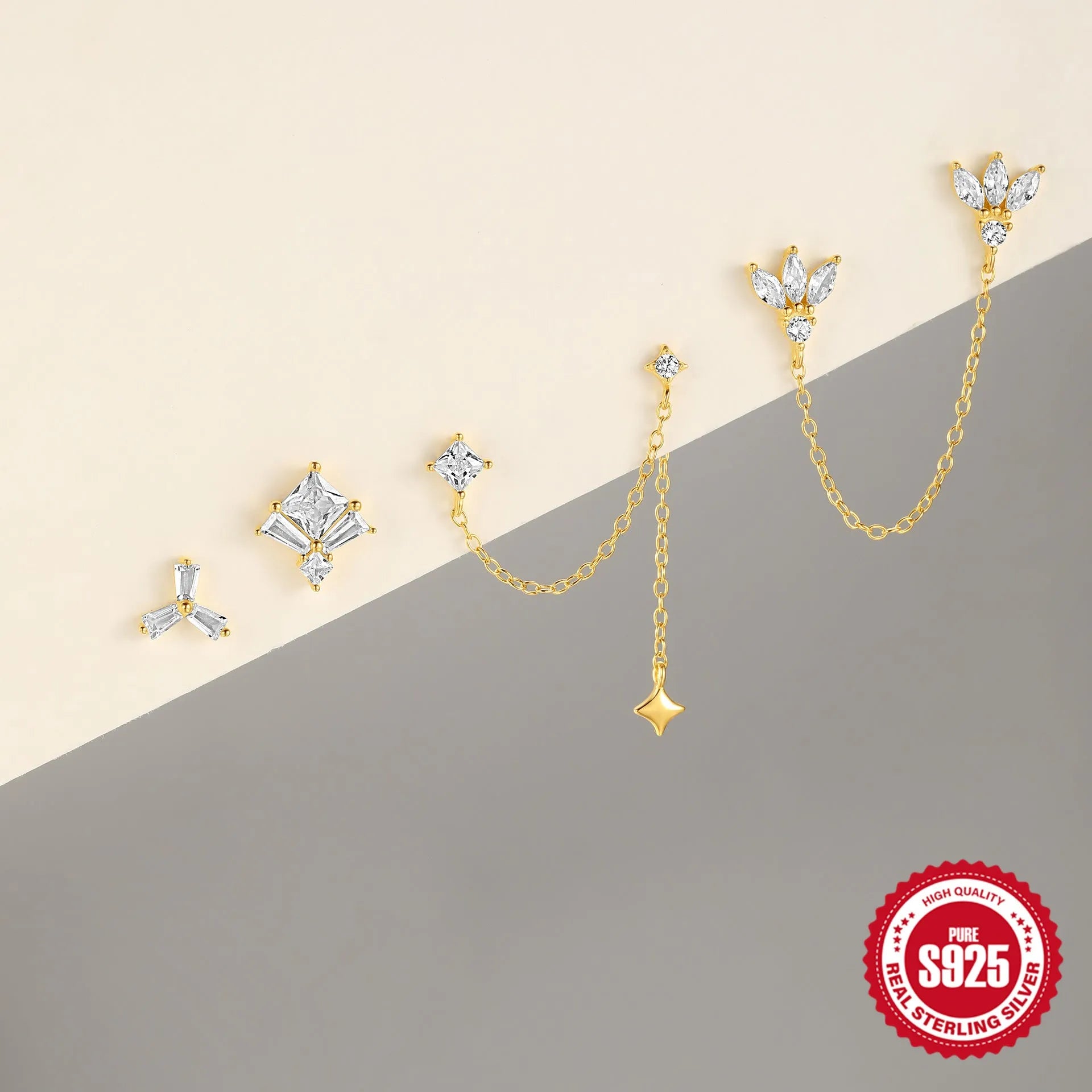 Gold colour sterling silver stud earrings with a connecting chain and inlaid zircon stones.