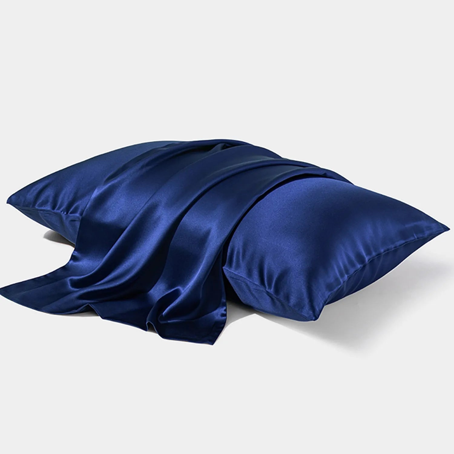 Dark gray 19 M silk envelope pillowcase with envelope closure on a bed.