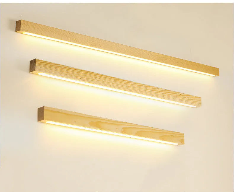 Modern walnut-colour wooden log strip LED wall lamp mounted on a wall.