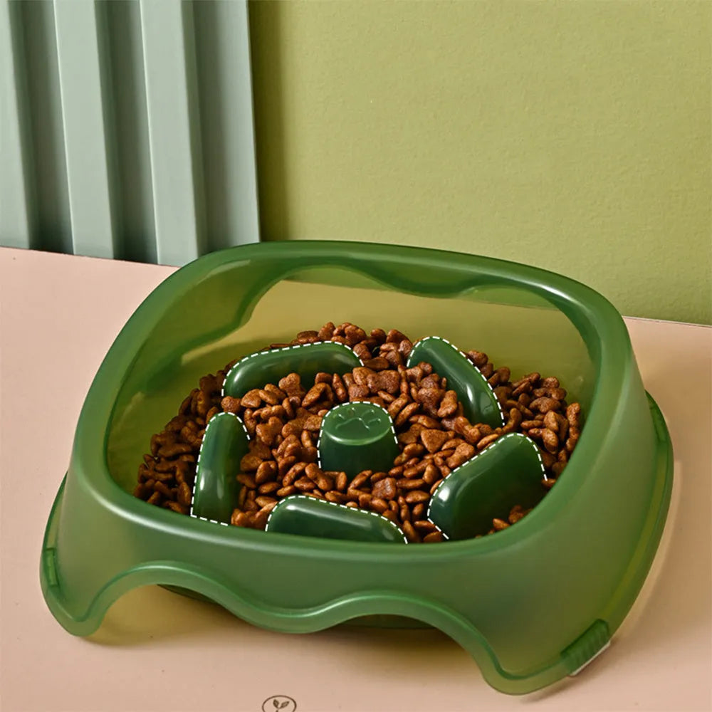Blue plastic slow-feeder dog bowl on a wooden floor.