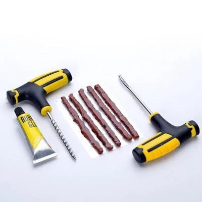 Black and yellow vacuum tyre repair tool kit with probe, pin, glue, and rubber strips on plastic packaging.
