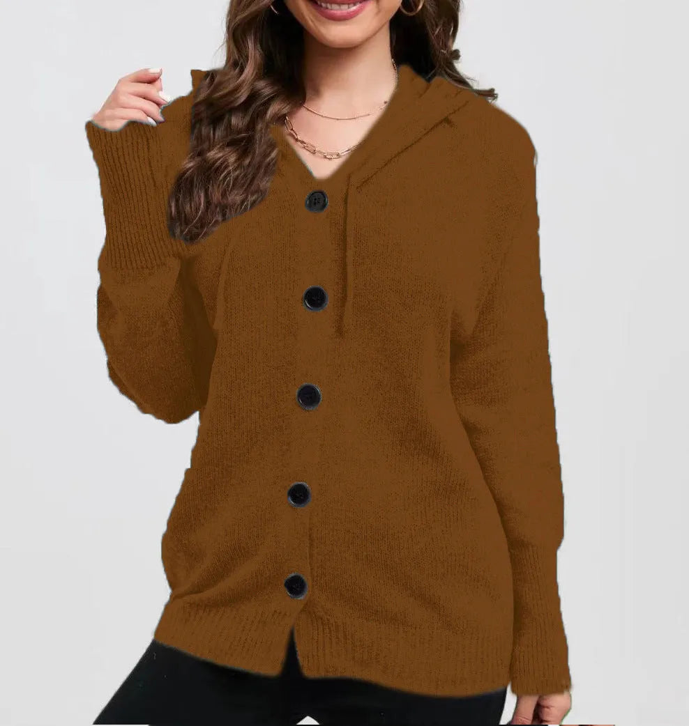 Woman wearing a thick, loose-fit hooded cardigan sweater in a solid colour.