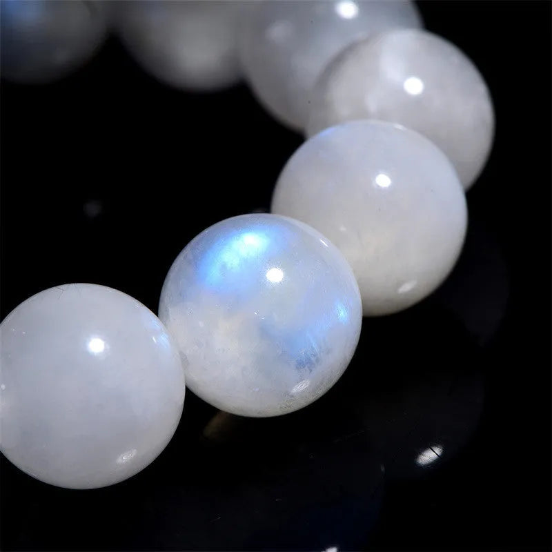 Natural blue moonlight moonstone round bead bracelet showing polished stone surface and blue sheen