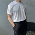 Men's slim fit cotton T-shirt in black on a hanger, showing round neck and regular sleeve.