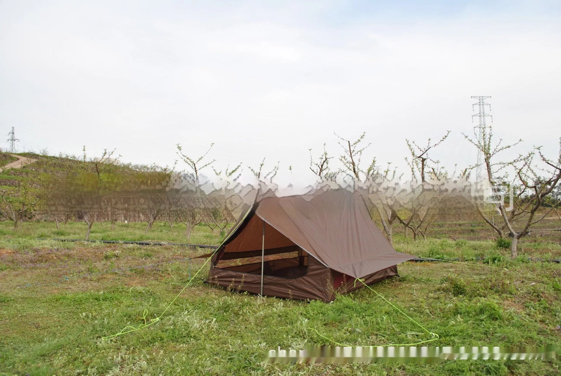 Brown A-line trekking tent pitched using hiking poles with dimensions 210x150x110cm