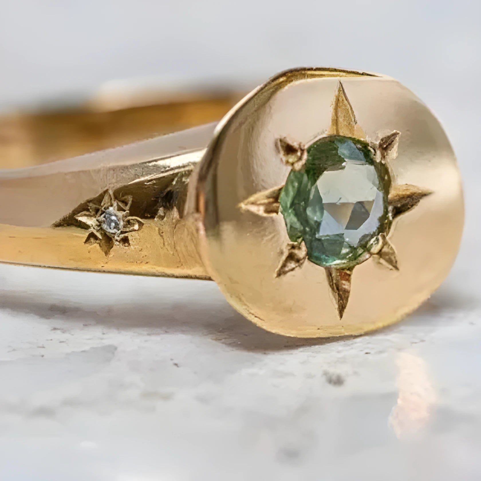 Gold tone adjustable ring with oval band and star-shaped zircon stone.