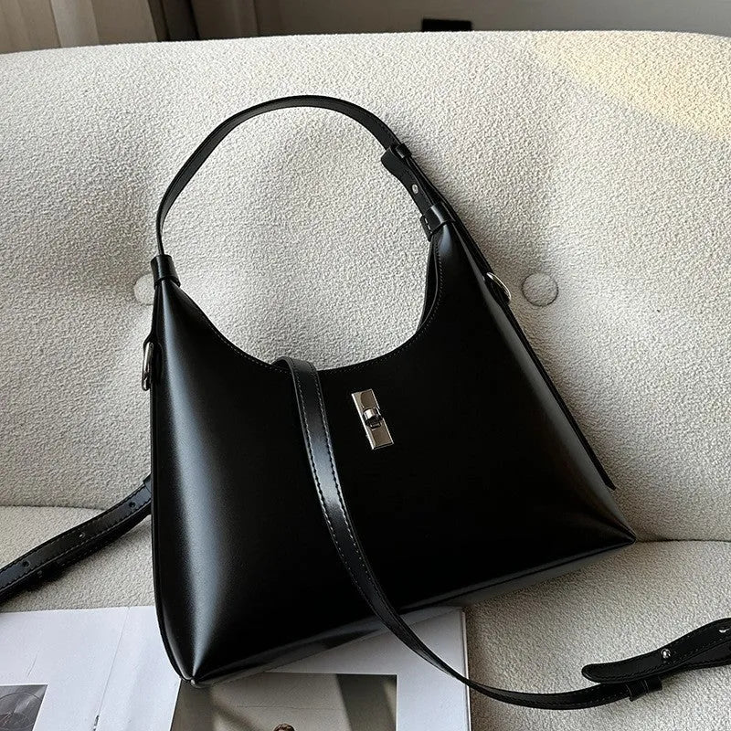 Soft brown genuine leather dumpling-shaped crossbody bag with a front sandwich pocket.