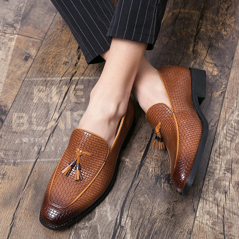 Men's black pointed toe slip on loafers with a tassel detail on the front.